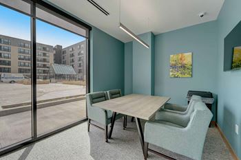 a dining room with a table and chairs and a large window
